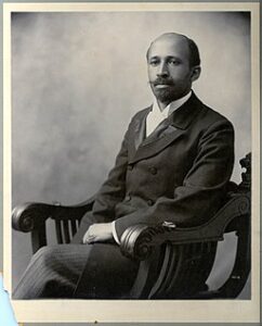 W.E.B Du Bois sitting in a chair.